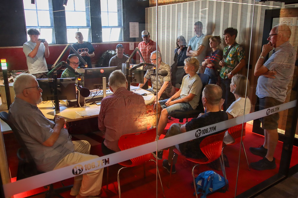 Peter Merrett's final show in studio 1 at PBS, surrounded by 16 people consisting of fans, friends and family