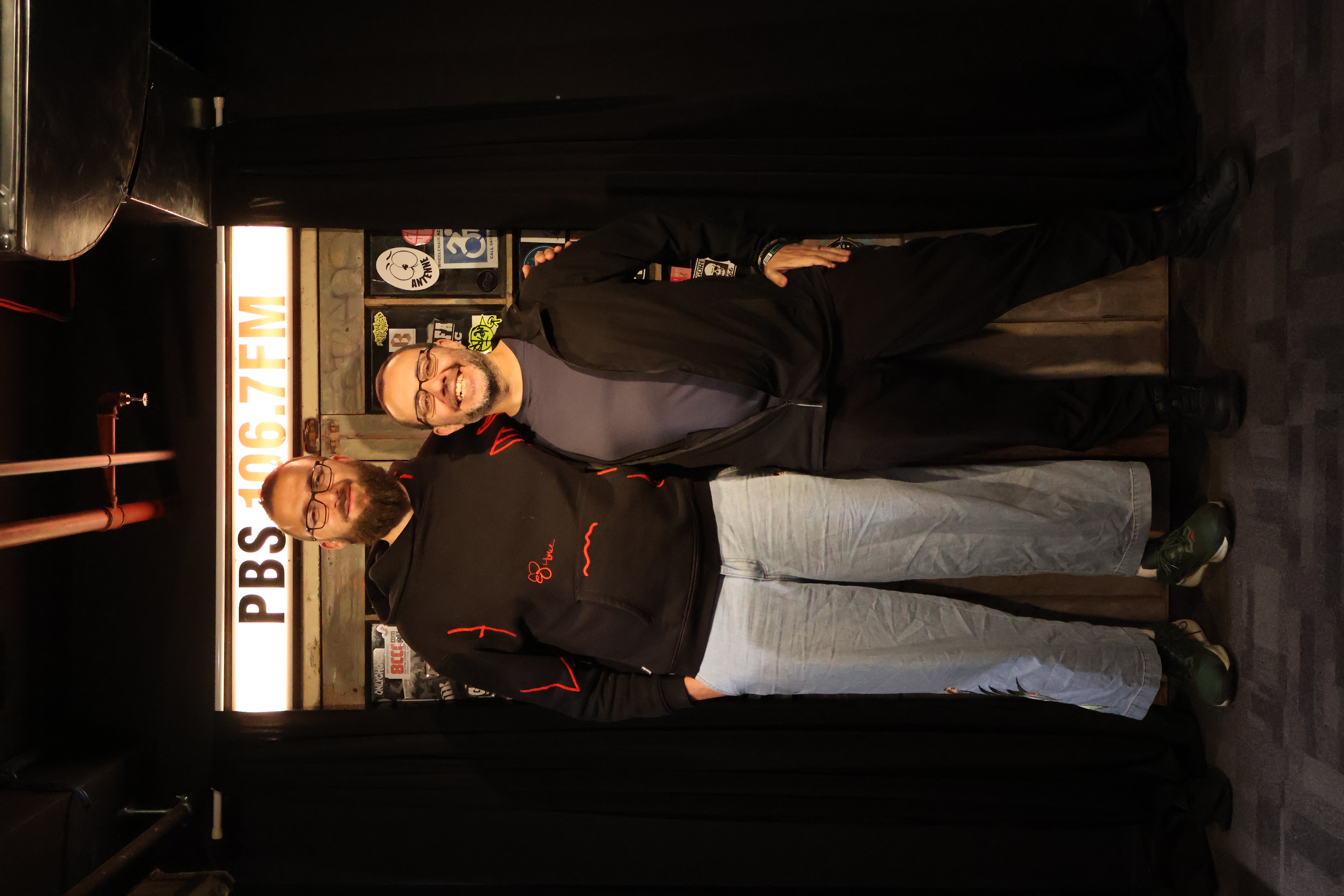 Luqman and DJ Matab pose by PBS doors