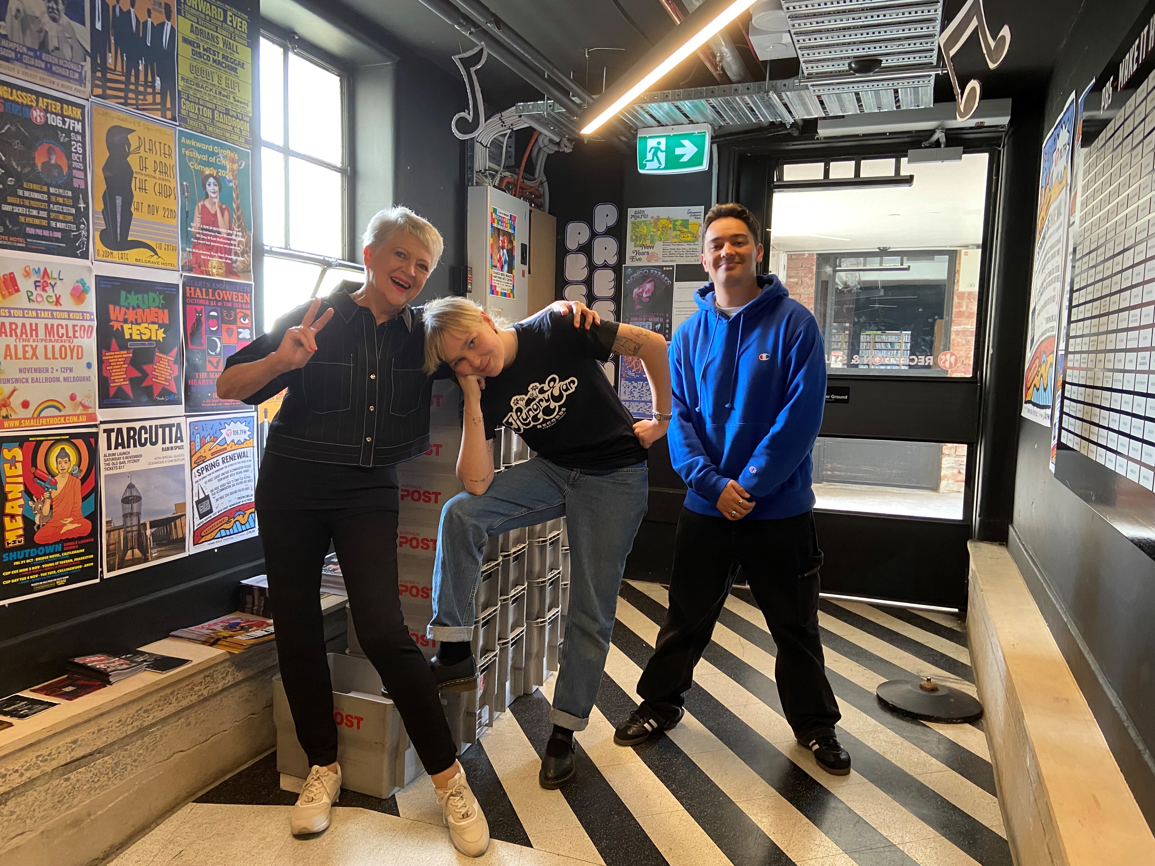 Sue, Lucia and Kurtis stand with the outgoing mail boxes packed