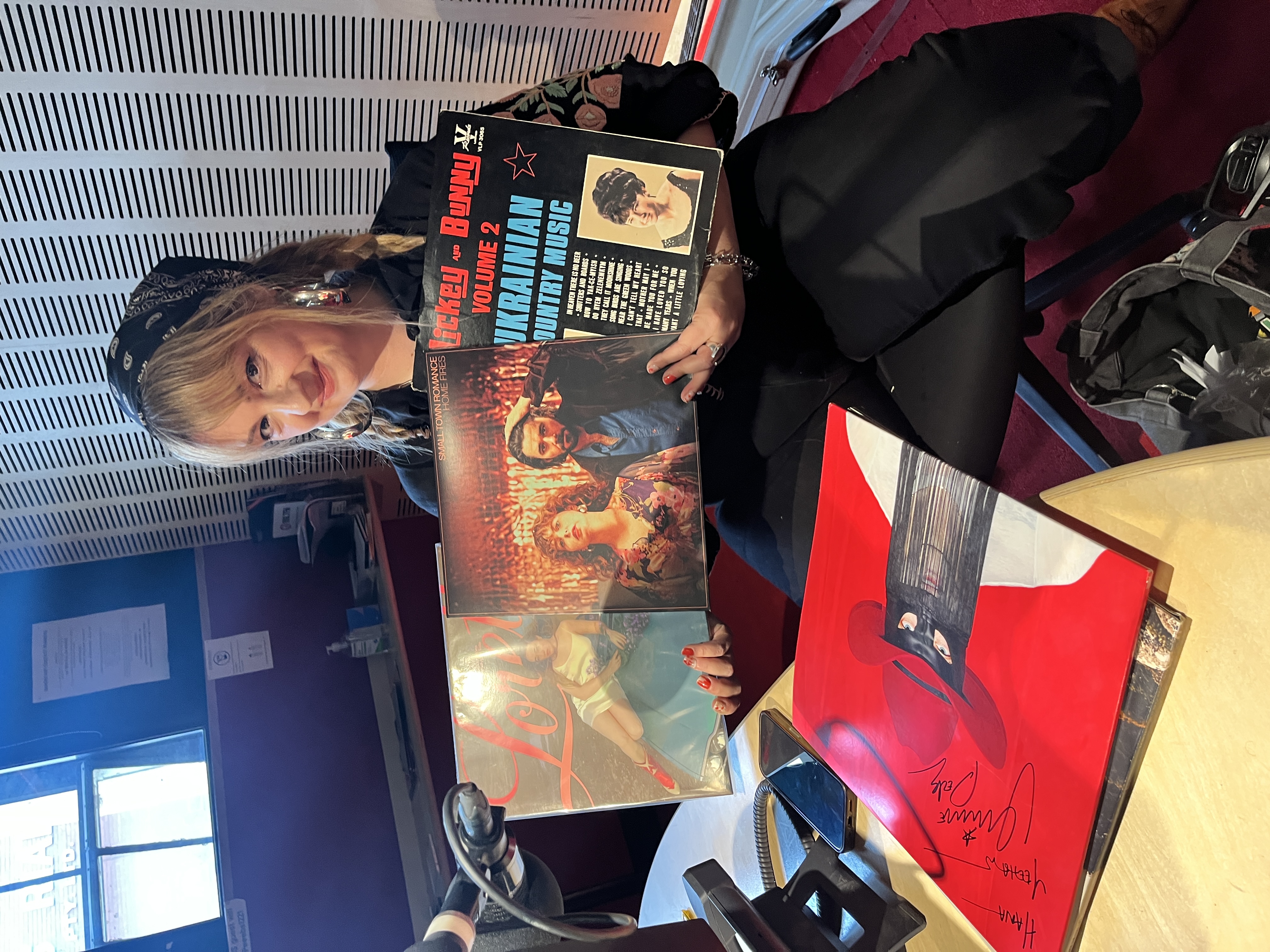 The artist Hana Brenecki guest host of Swinging Doors in Studio, holding up country records