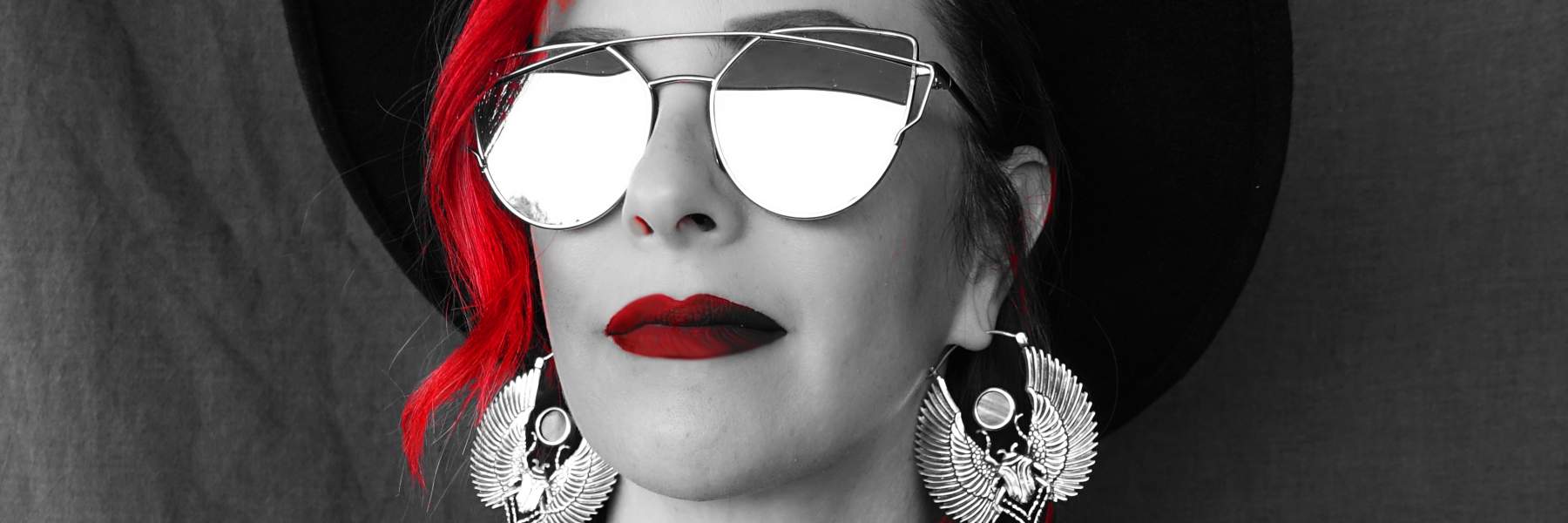 Kristen Solury with red hear and lipstick, wearing reflective sunglasses