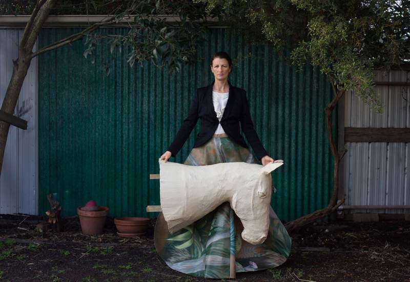 Jacqui Stockdale poses with one of her art pieces